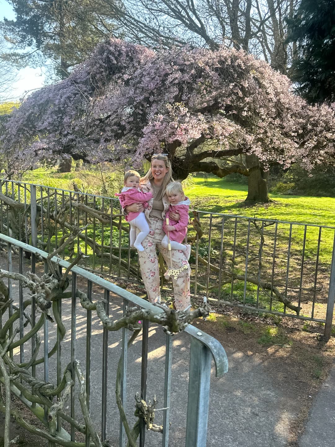 Emma with her two daughters under a flowering cherry blossom tree