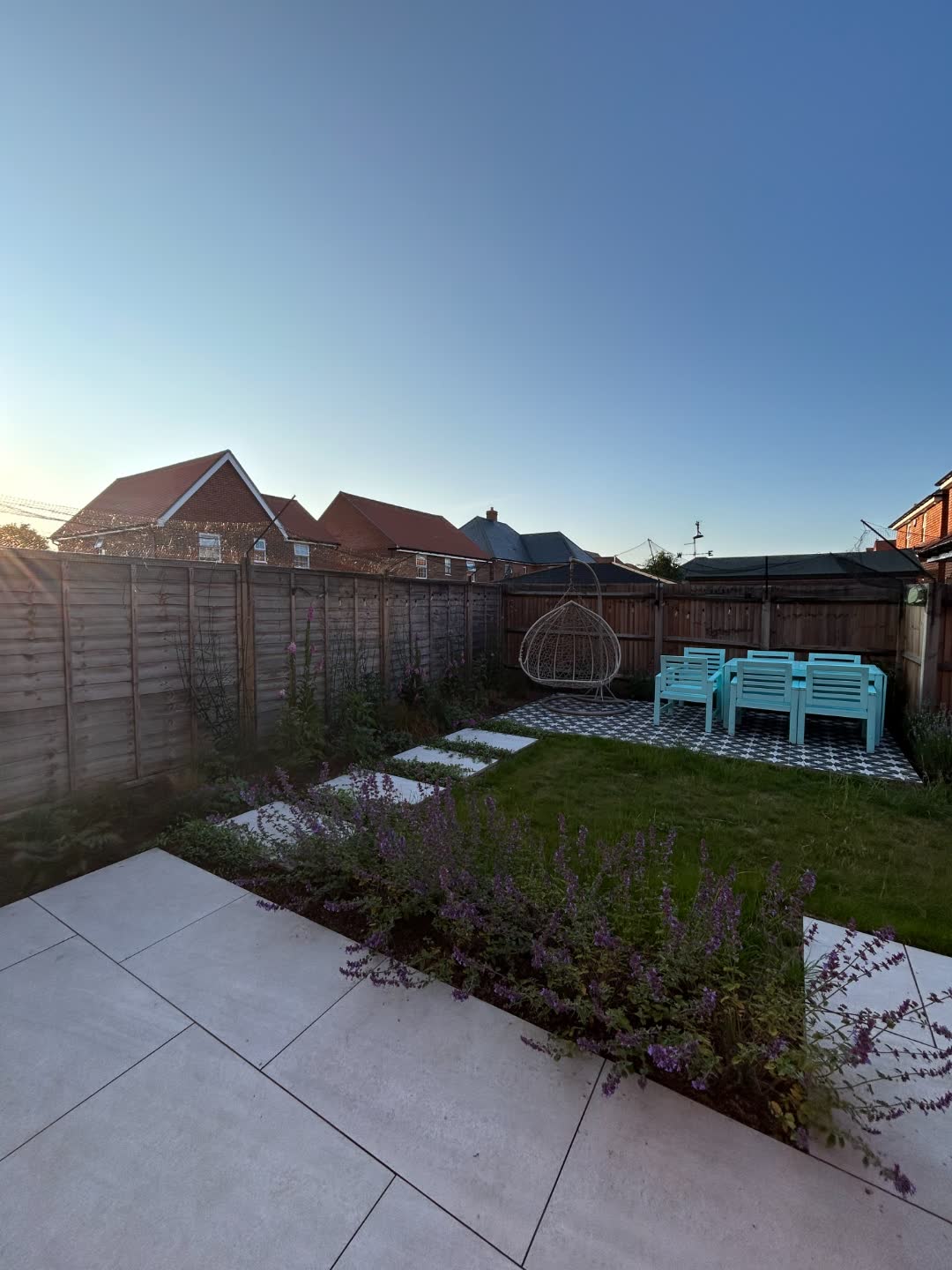 The same garden at golden hour, looking back from the patio